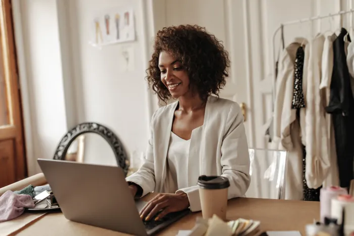 A business owner working happily at her desk in a cosy office